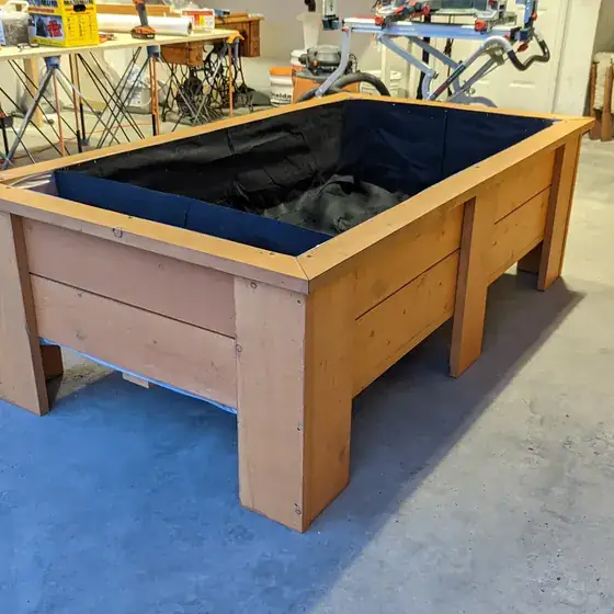 A raised garden bed he built from scratch, lined and filled