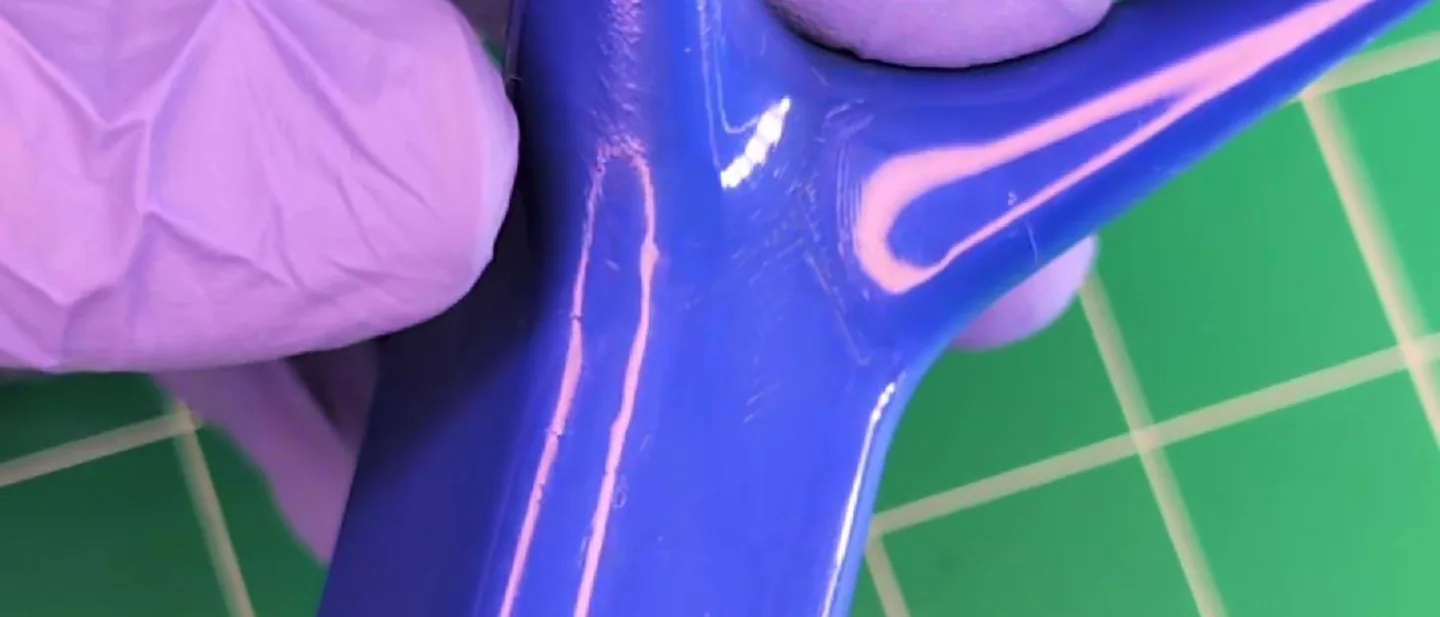 The same blue part after the compound, throwing a hard highlight down its length.